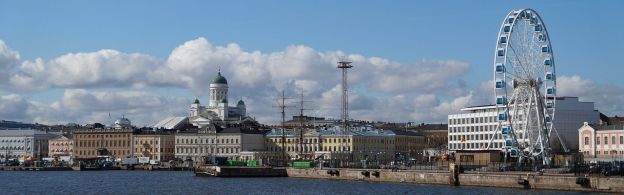 A wide view of the harbor in Helsinki, Finland, in daytime. The view features several landmarks, including Helsinki Cathedral.